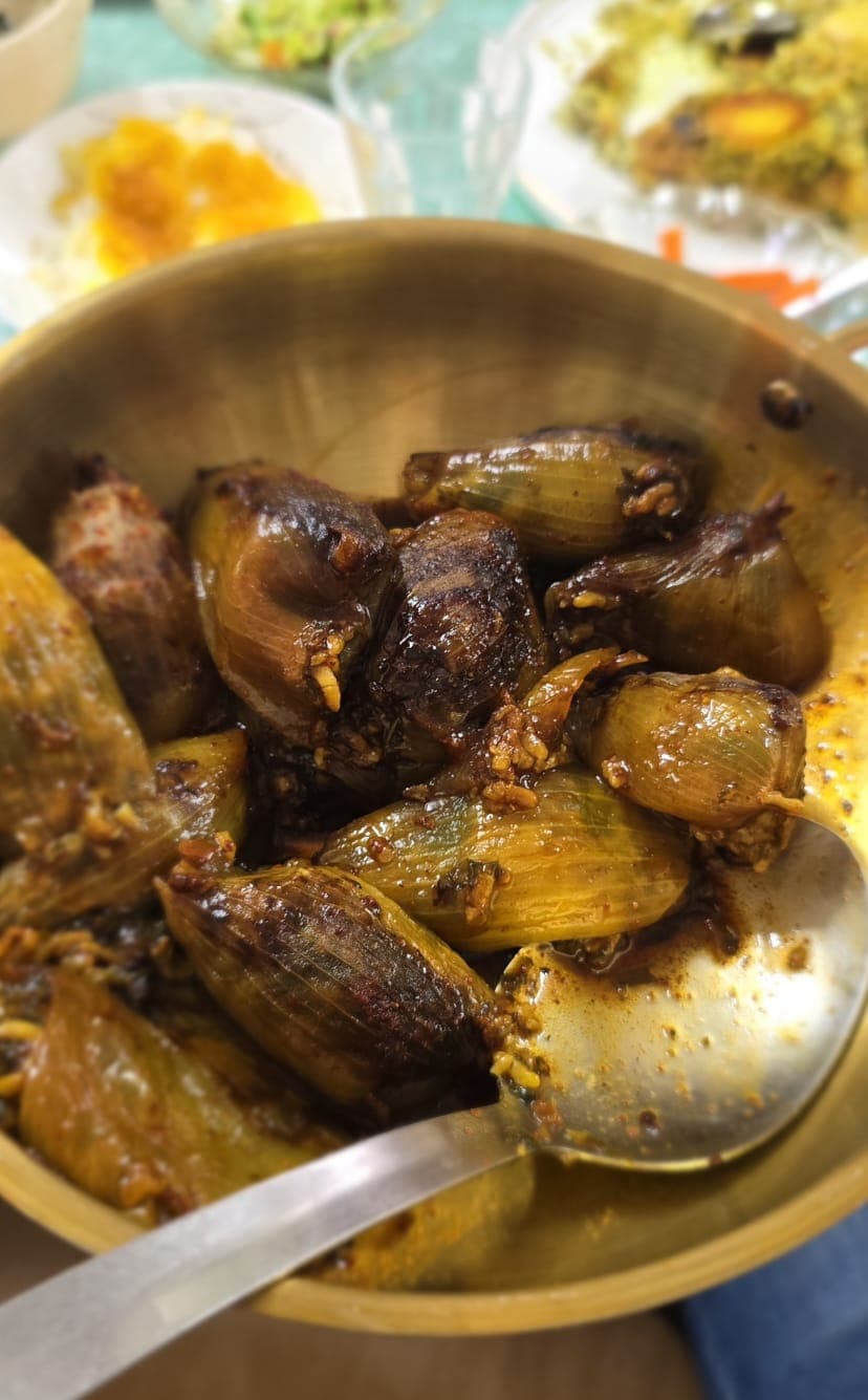 Stuffed onions — Persian onion dolma in a brass bowl with a deep brown sauce