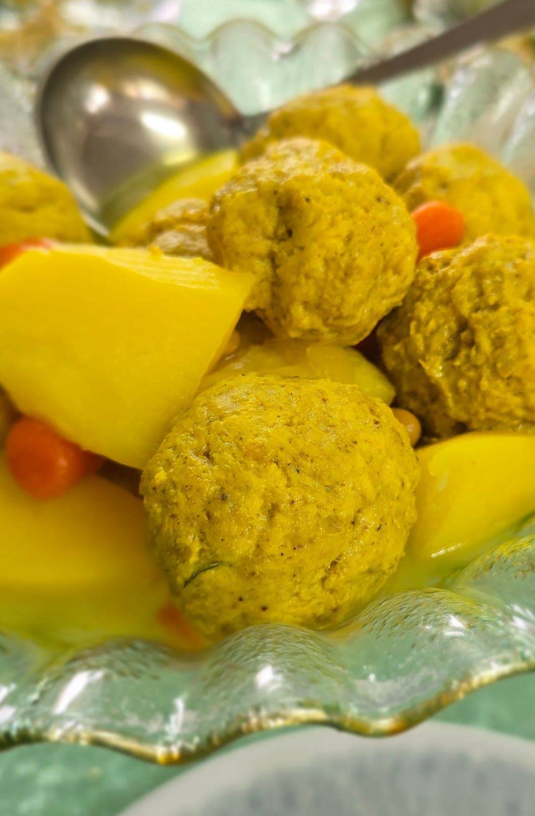 Gondi — Persian-Jewish chickpea-flour chicken dumplings in a glass bowl with potatoes and carrots
