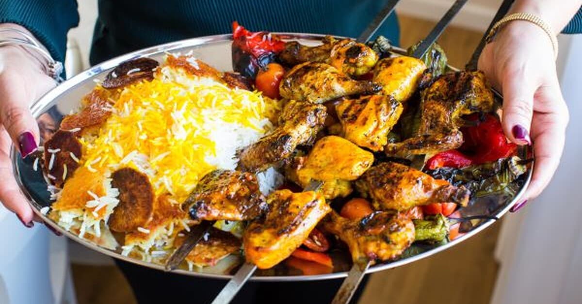 Juje Kabab — Persian grilled chicken skewers on a bed of saffron rice with charred vegetables