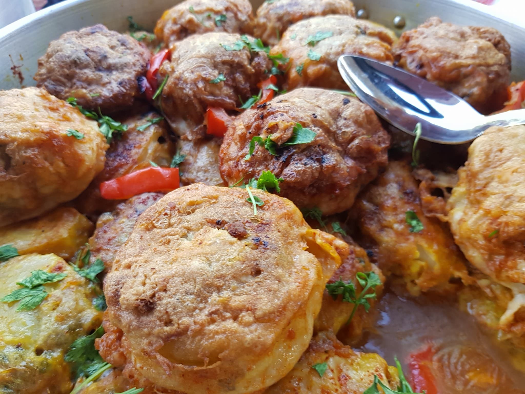 Maproum — potatoes stuffed with spiced beef mince, simmered in tomato sauce